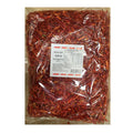 A clear plastic bag filled with sliced red chili peppers, with a white product label in the center, photographed against a plain white background.