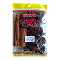 A clear plastic bag of Kambow beef stock seasoning mix, containing cinnamon sticks, star anise, and other spices, with a yellow and red header.