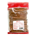 A clear plastic bag of cinnamon bark with a red header and a white product label, photographed against a plain white background.