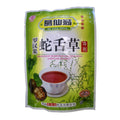 A package of Ge Xian Weng herbal tea extract powder, featuring a green and white bag with Chinese text, illustrations of snake gourd leaves and seeds, and a cup of the brewed red tea extract.