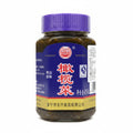A bottle of Dongxing Yihui Chinese cabbage salad seasoning with a purple cap and a blue label featuring red Chinese characters.
