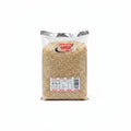 A 1kg bag of Jasmine Brown Rice from Kam Bow Group, displayed on a metal wire shelf. The transparent plastic bag shows the light brown rice grains inside, with a white and red label at the bottom containing nutritional information and product details.