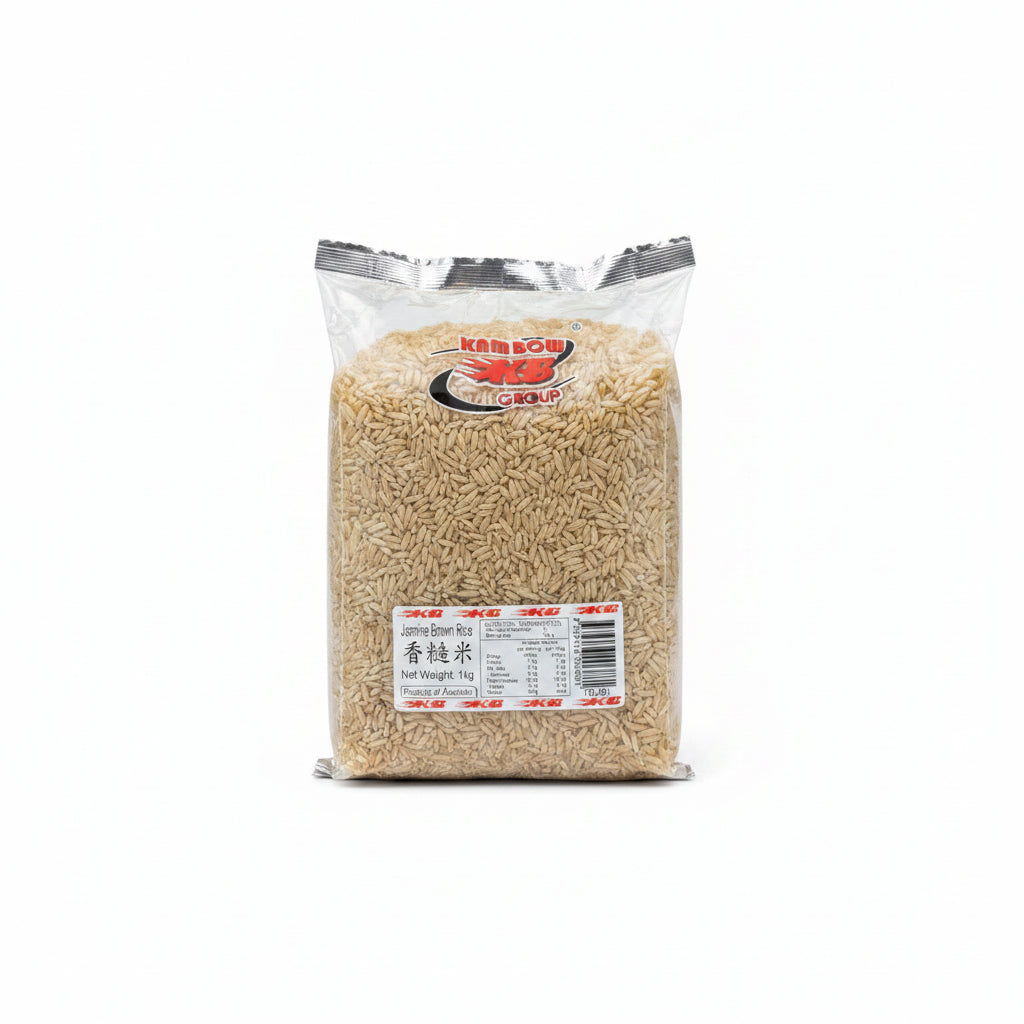 A 1kg bag of Jasmine Brown Rice from Kam Bow Group, displayed on a metal wire shelf. The transparent plastic bag shows the light brown rice grains inside, with a white and red label at the bottom containing nutritional information and product details.